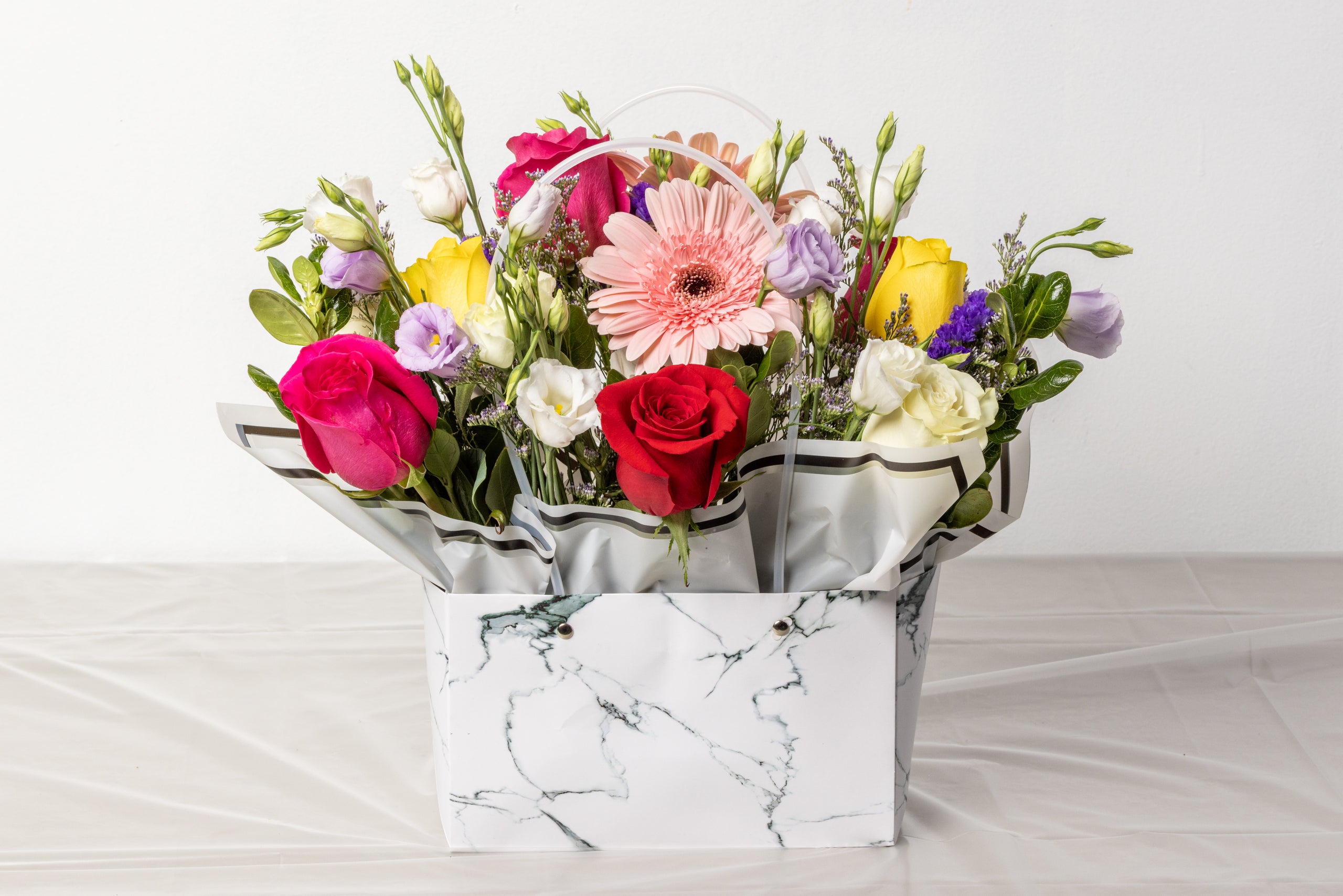 Santos Purse Arrangement Assorted Flowers w White Marble Bag Santos Flowers
